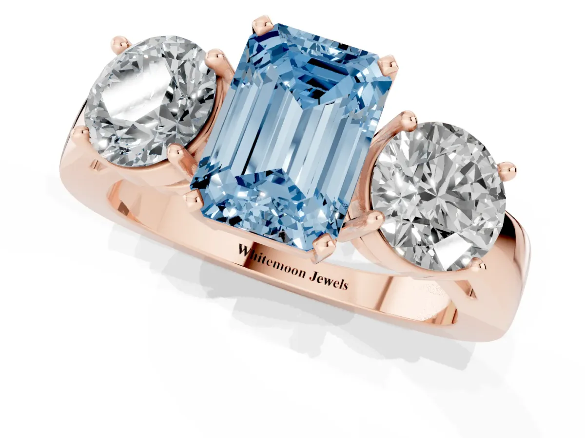 Fancy Blue Three-Stone Emerald Cut Diamond Ring with Round Side Stones, Classic Band, and Four-Prong Setting Rose gold