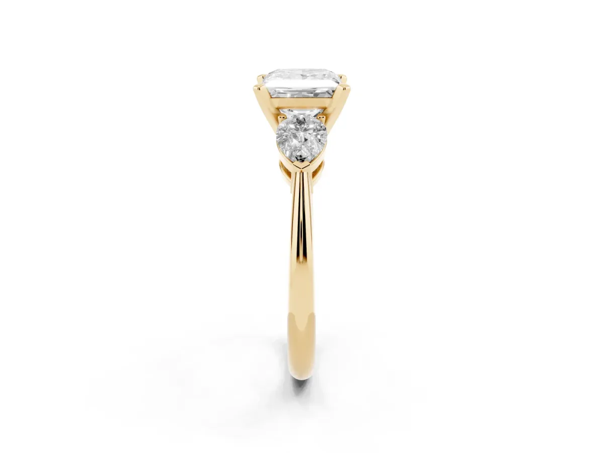 Three-Stone Princess Cut Diamond Ring with Pear Side Stones and Four-Prong Setting Yellow gold