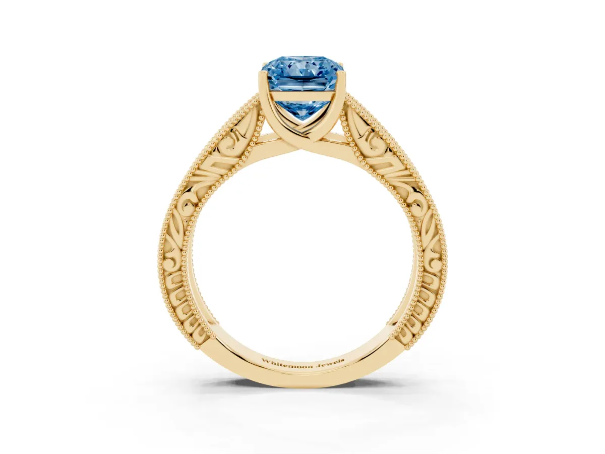 Fancy Blue Radiant Cut Diamond Solitaire Ring with Engraved Band and Four-Prong Setting Yellow gold