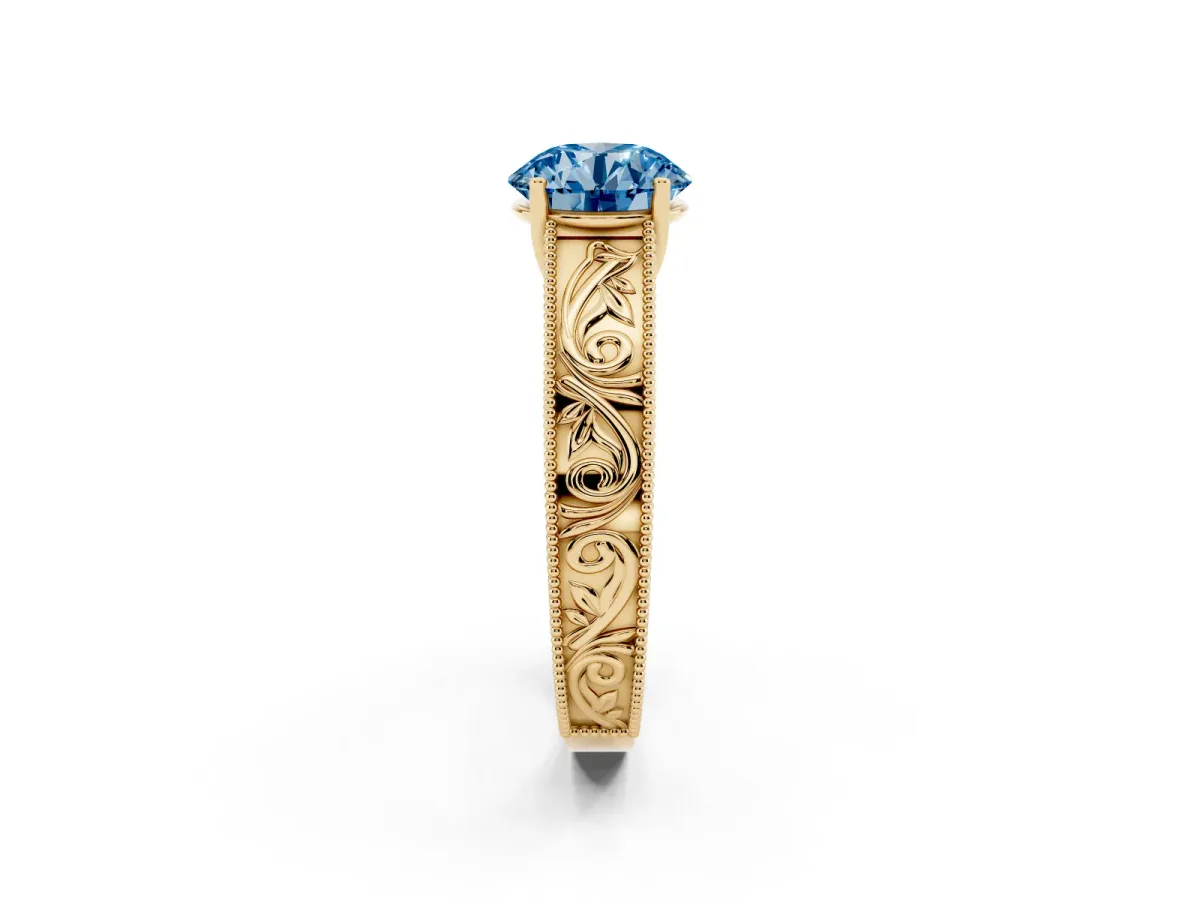 Fancy Blue Round Cut Diamond Solitaire Ring with Engraved Band and Four-Prong Setting Yellow gold