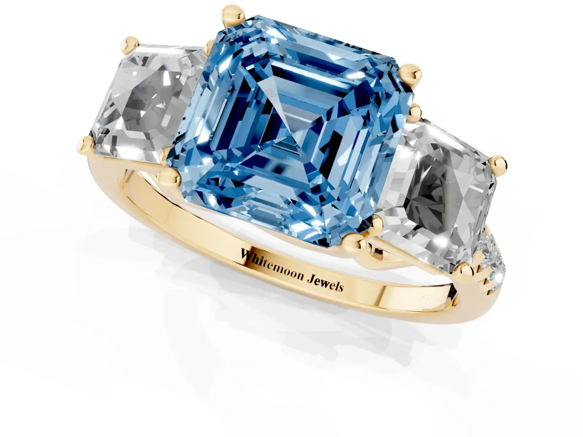 Fancy Blue Three-Stone Asscher Cut Diamond Ring with Round Pavé Band and Prong Setting Yellow gold
