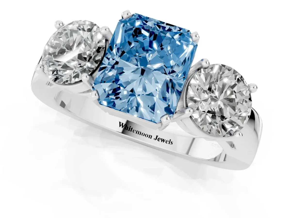 Fancy Blue Three-Stone Radiant Cut Diamond Ring with Round Side Stones, Classic Band, and Four-Prong Setting Platinum