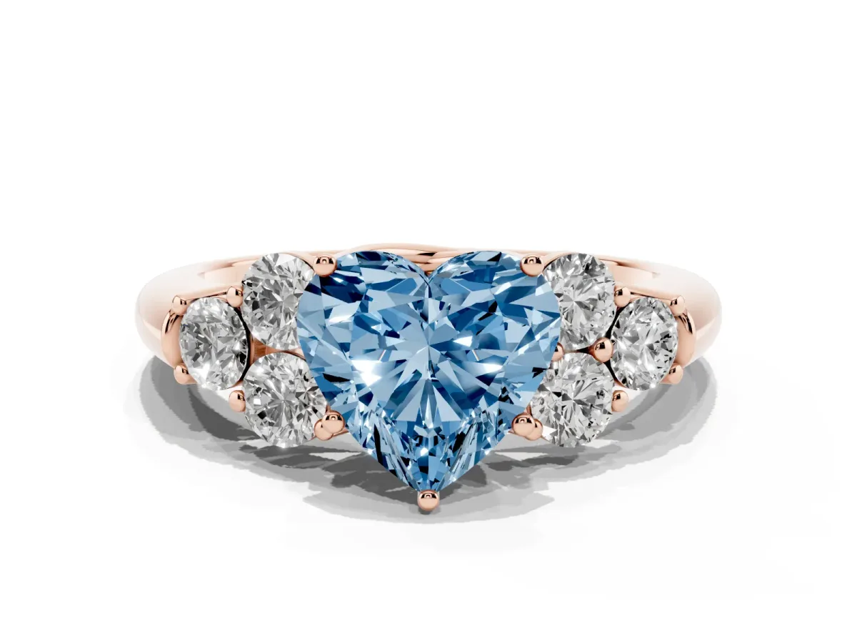 Fancy Blue Heart Cut Cut Diamond Cluster Ring with Round Accent Stones and Prong Setting on a Classic Band Rose gold