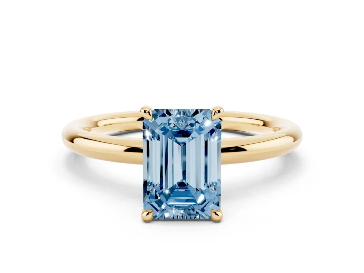 Fancy Blue Emerald Cut Diamond Solitaire Ring with Thin Band and Four-Prong Setting Yellow gold