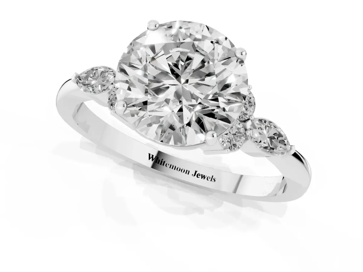 Round Cut Brilliant Diamond Solitaire Ring with Pear Side Stones and Four-Prong Setting Silver