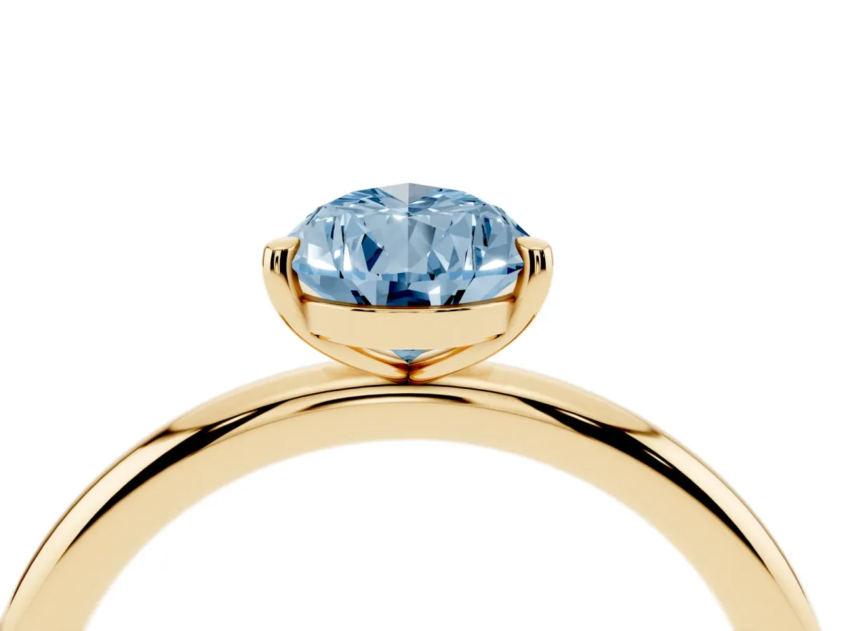 Fancy Blue Pear Cut Solitaire Diamond Ring with Four-Prong Setting on a Plain Band Yellow gold