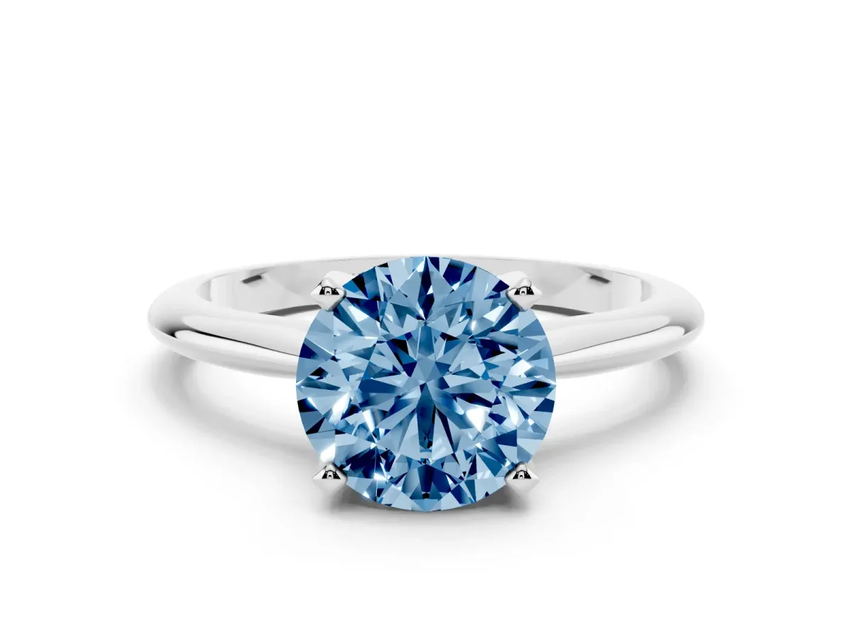 Fancy Blue Round Cut Cut Solitaire Ring with Four-Prong Setting on a Classic Band Silver