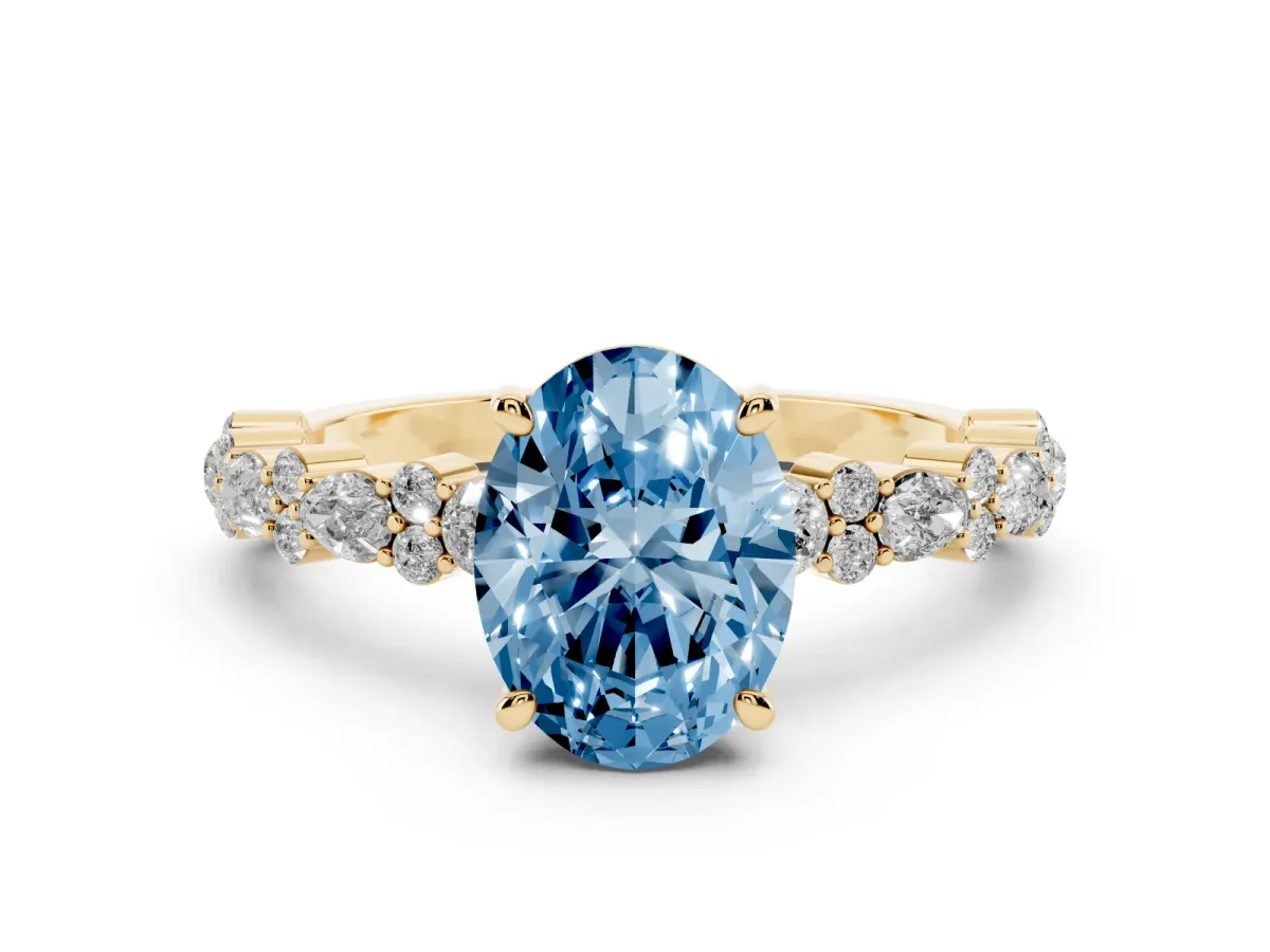 Fancy Blue Oval Cut Diamond Side Stone Solitaire Ring with Round and Four-Prong Setting Yellow gold