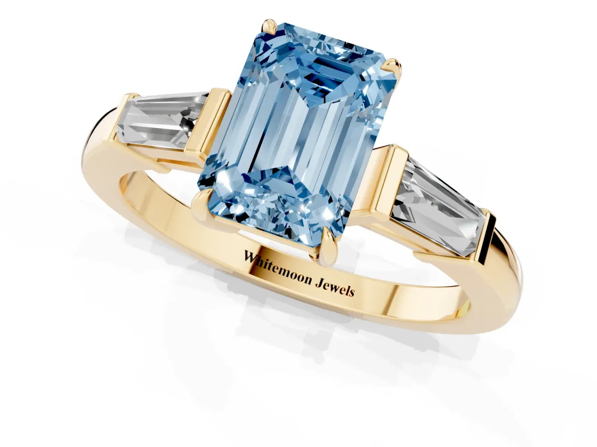 Fancy Blue Emerald Cut Diamond Three-Stone Ring with Tapered Baguette Side Stones and Prong Setting Yellow gold