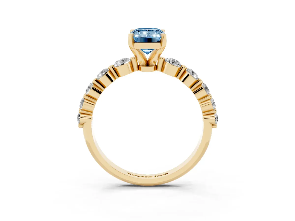 Fancy Blue Emerald Cut Solitaire Diamond Ring with Pave Band and Four-Prong Setting Yellow gold