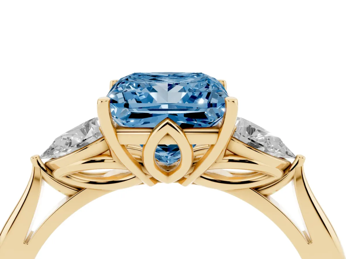 Fancy Blue Three-Stone Princess Cut Diamond Ring with Pear Side Stones in Four-Prong Setting Yellow gold