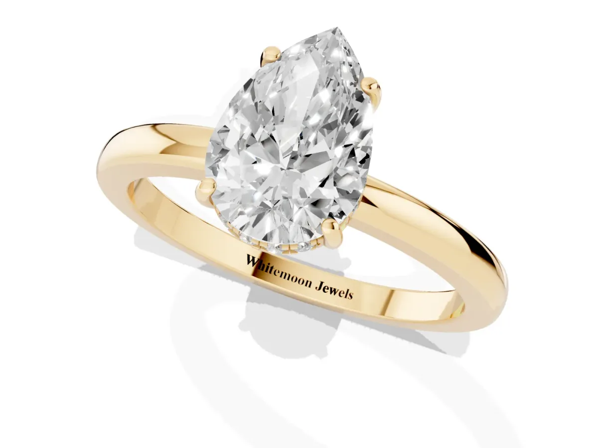 Pear Cut Solitaire Diamond Ring with Prong Setting and Plain Band Yellow gold