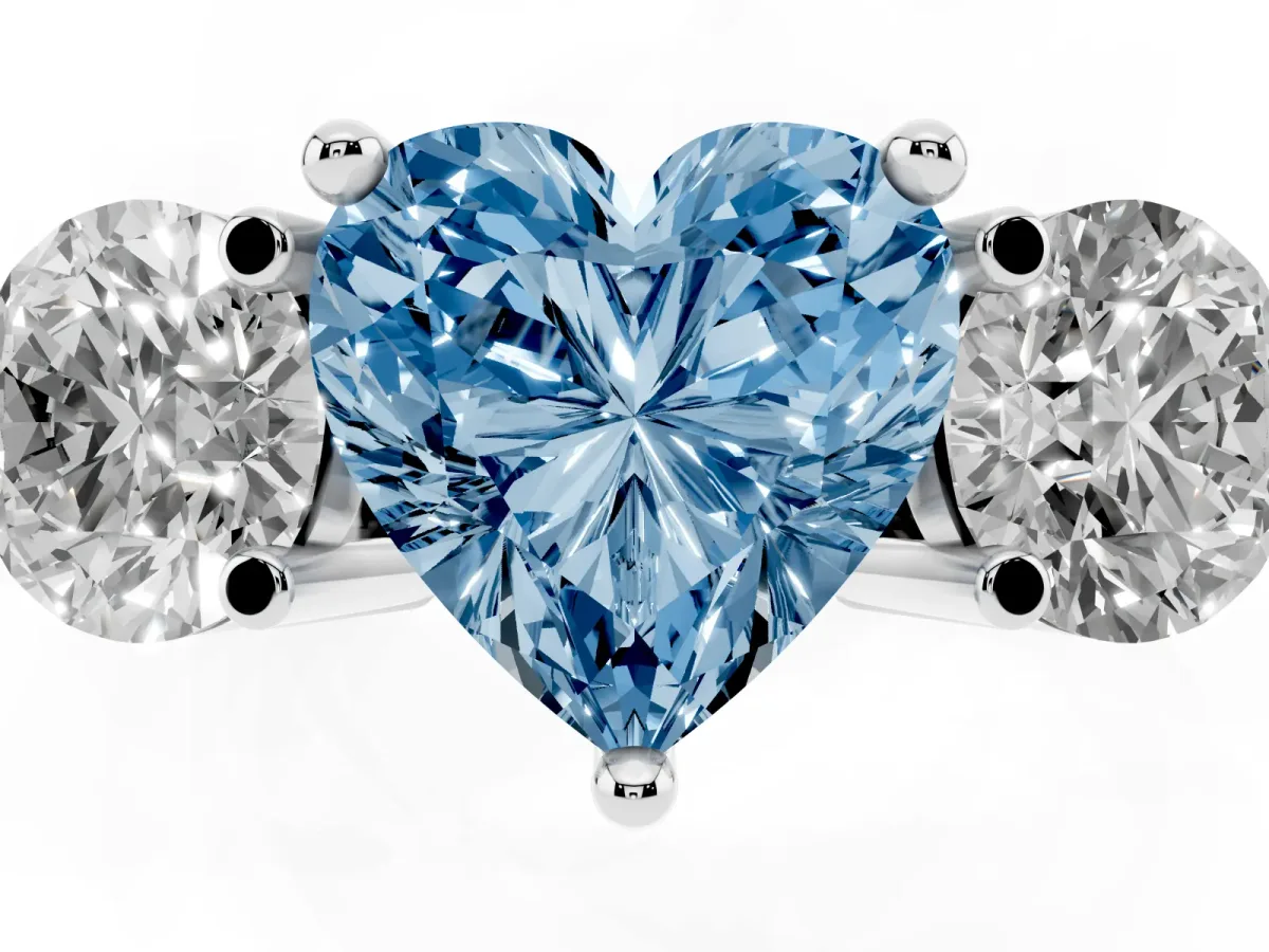 Fancy Blue Three-Stone Heart Cut Brilliant Cut Solitaire Ring with Prong Setting on a Classic Band Silver