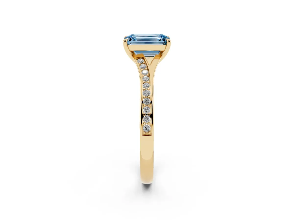 Fancy Blue Emerald Cut Diamond Solitaire Ring with Pavé Band and Prong Setting Yellow gold