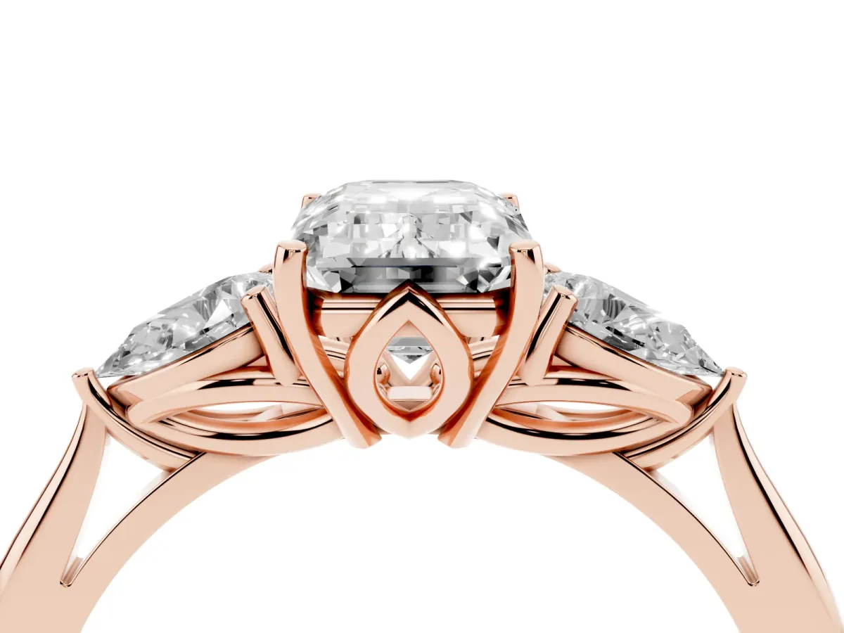 Three-Stone Emerald Cut Diamond Ring with Pear Side Stones in Four-Prong Setting Rose gold