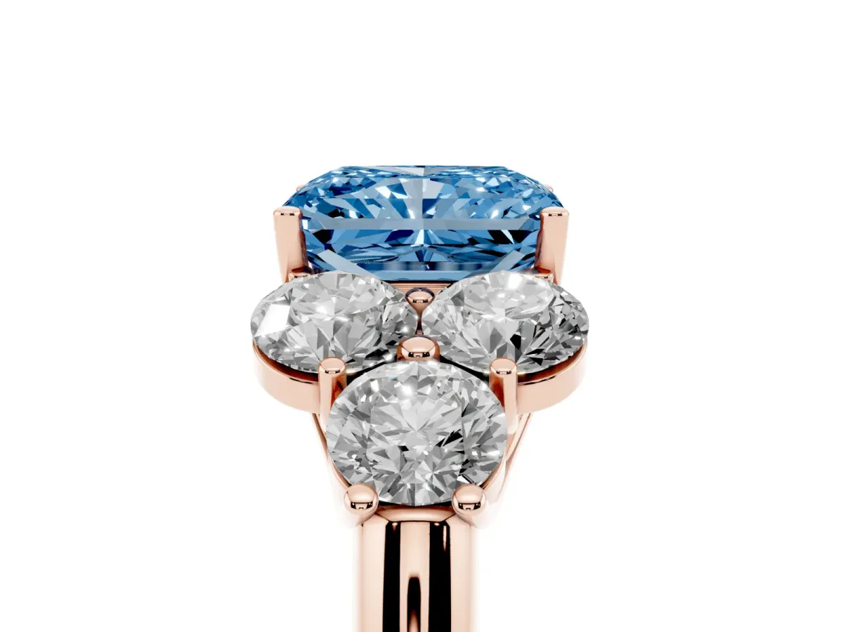 Fancy Blue Radiant Cut Cut Diamond Cluster Ring with Round Accent Stones and Prong Setting on a Classic Band Rose gold