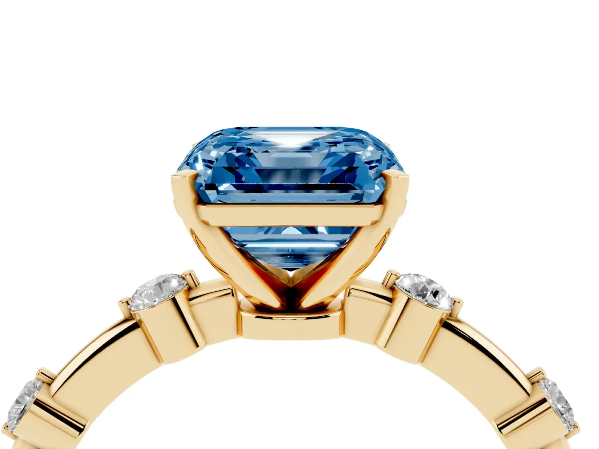 Fancy Blue Asscher Cut Solitaire Diamond Ring with Bezel Set Side Stones and Prong Setting Yellow gold