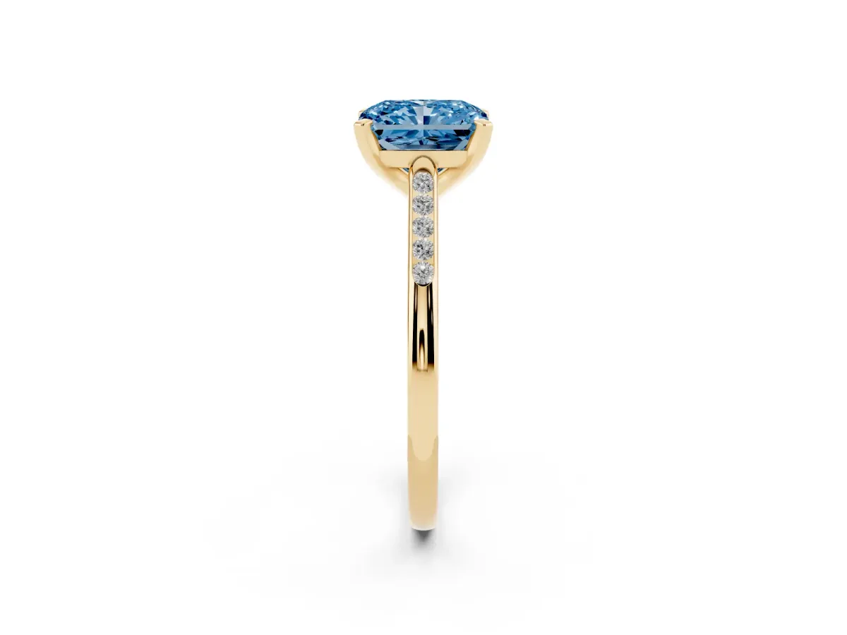 Fancy Blue Radiant Cut Diamond Solitaire Ring with Channel Set Round Band and Prong Setting Yellow gold