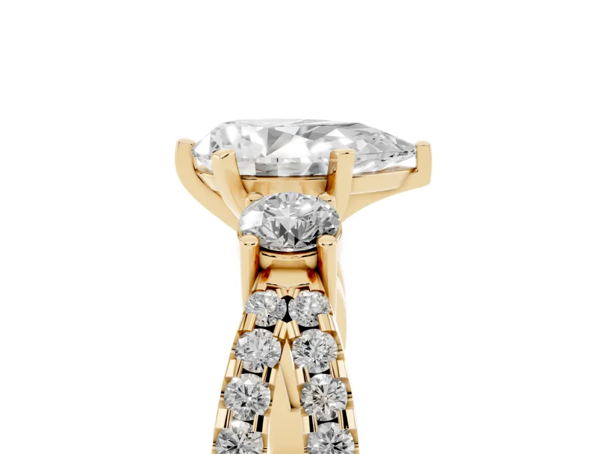 Pear Cut Diamond Three-Stone Ring with Pavé Split Shank and Four-Prong Setting Yellow gold