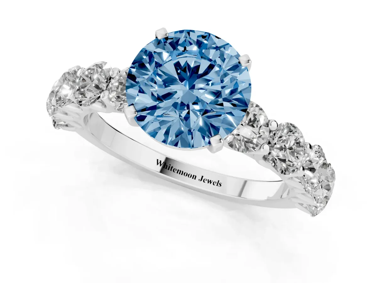 Fancy Blue Round Cut Diamond Prong Setting with Side Stones on a Pave Band Silver