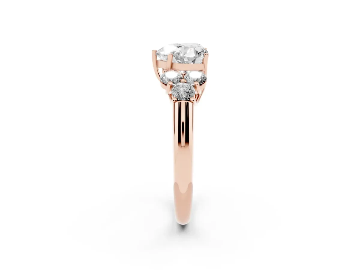 Heart Cut Cut Diamond Cluster Ring with Round Accent Stones and Prong Setting on a Classic Band Rose gold