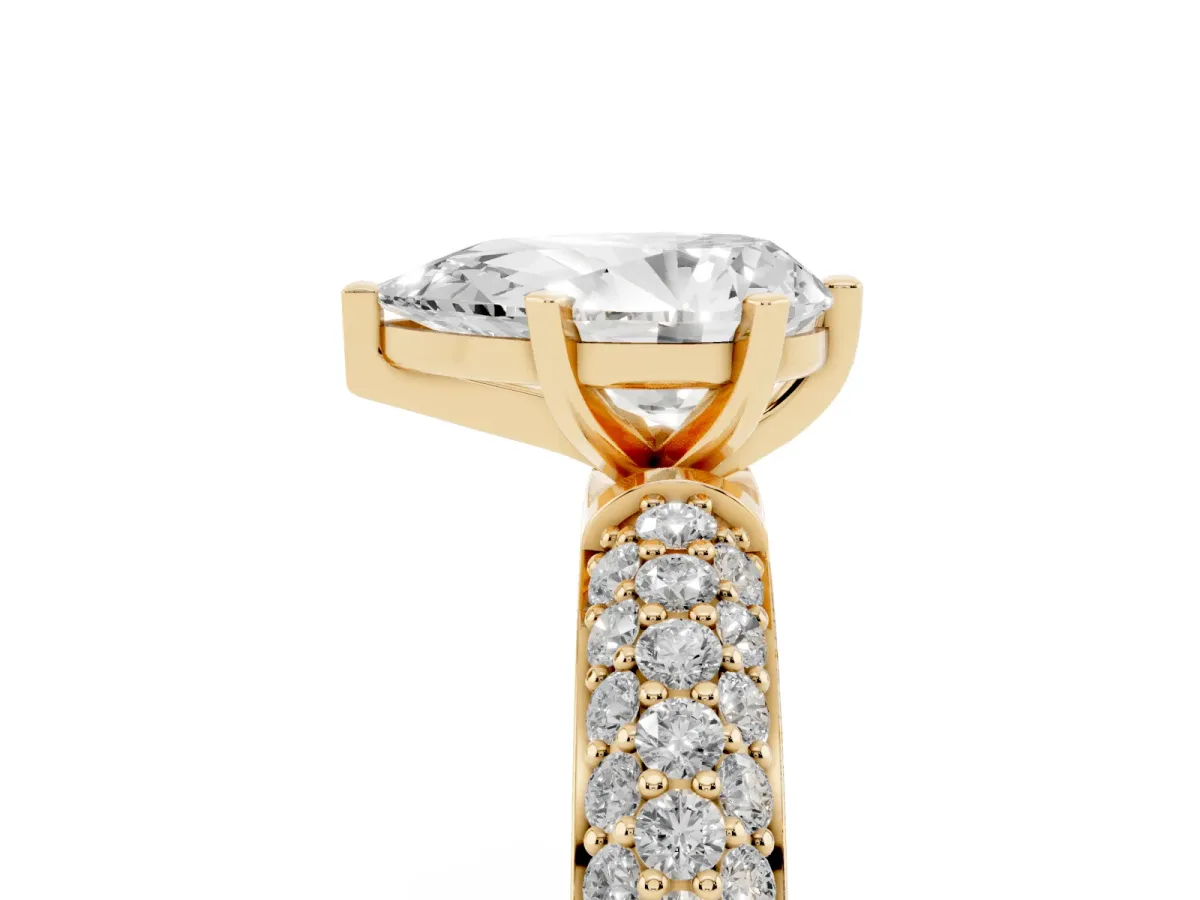 Pear Cut Diamond Solitaire Ring with Prong Setting and Pavé Band Yellow gold