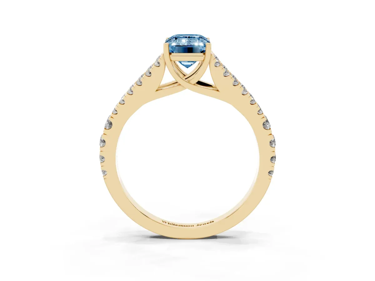 Fancy Blue Emerald Cut Diamond Split Shank Pavé Engagement Ring with Four-Prong Setting Yellow gold