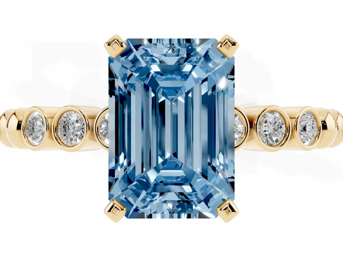 Fancy Blue Emerald Cut Solitaire Bezel Accent Diamond Engagement Ring with Beaded Band and Four-Prong Setting Yellow gold