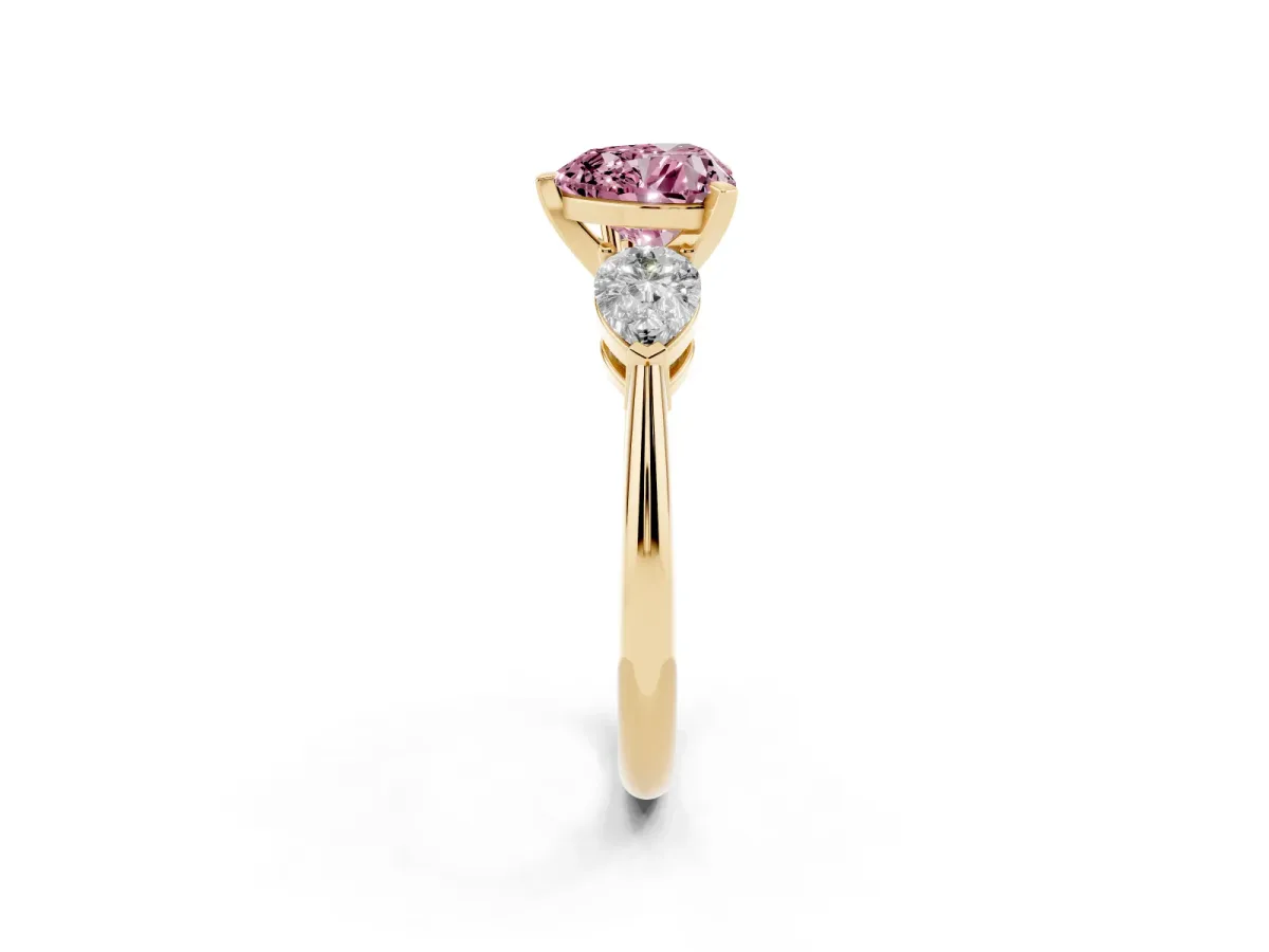 Fancy Pink Three-Stone Heart Cut Diamond Ring with Pear Side Stones and Four-Prong Setting Yellow gold