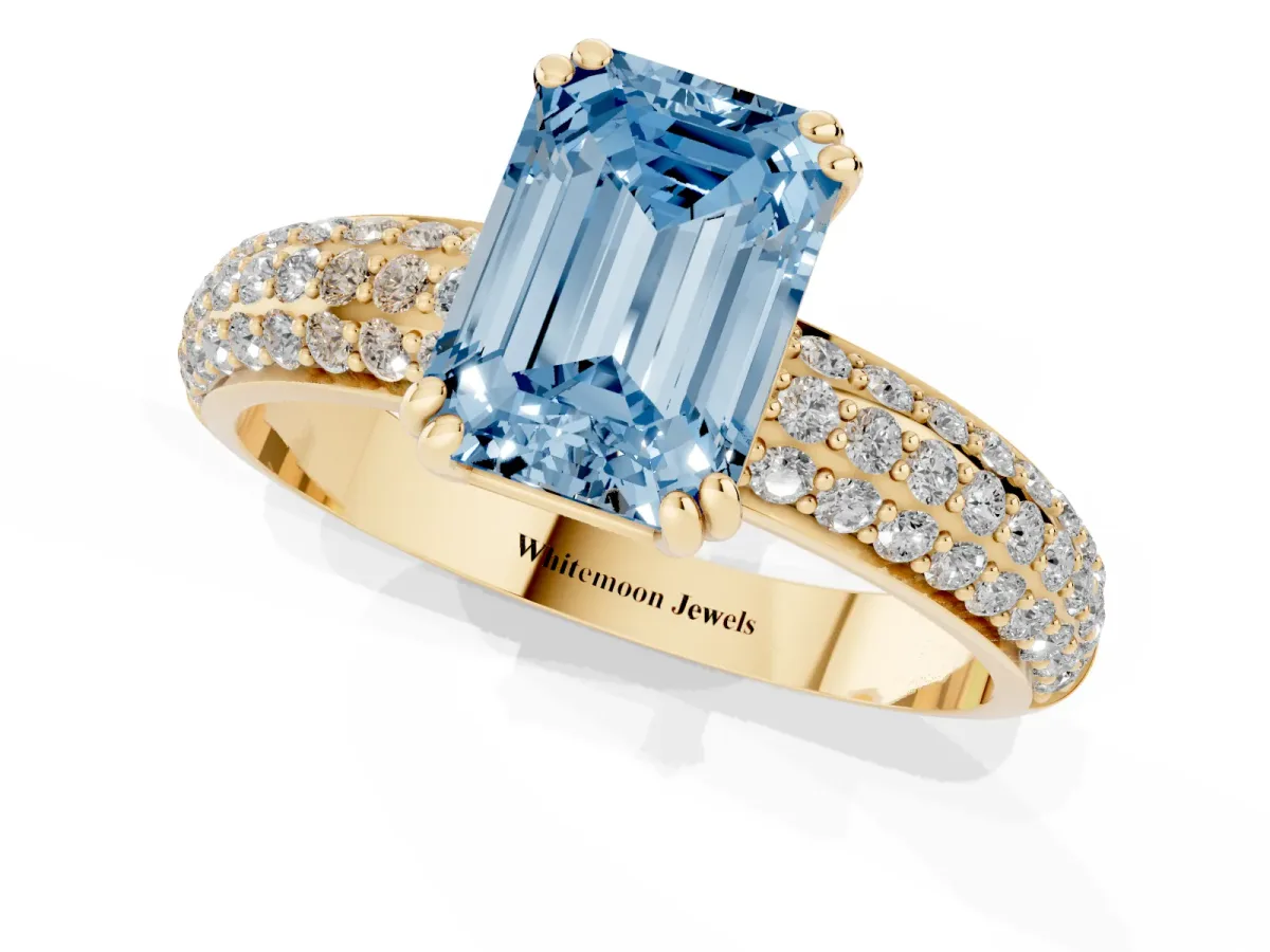 Fancy Blue Emerald Cut Diamond Solitaire Ring with Multi-Row Round Pavé Band and Prong Setting Yellow gold