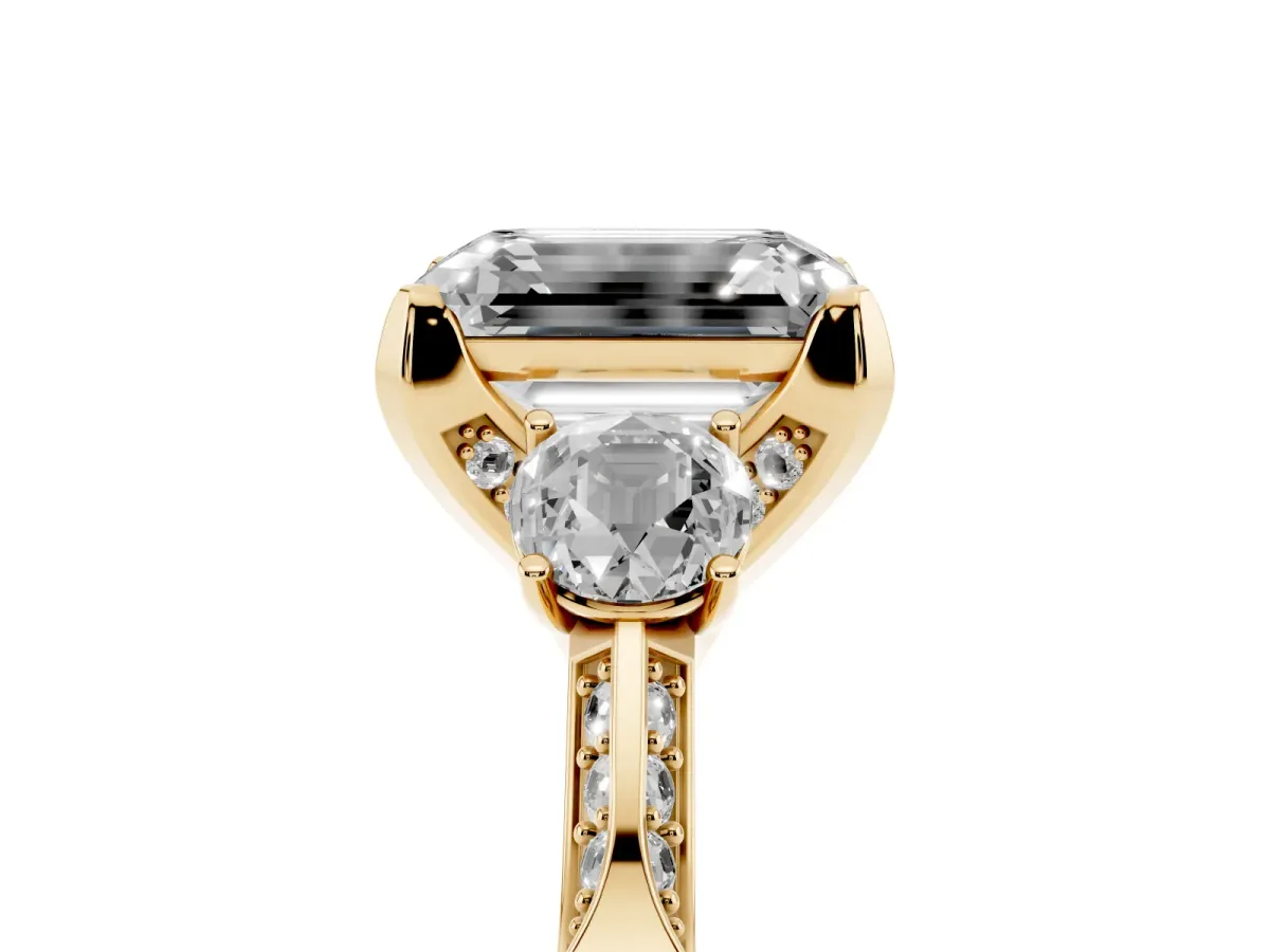 Fancy Pink Emerald Cut Brilliant Three-Stone Diamond Ring with Pavé Band and Four-Prong Setting Yellow gold