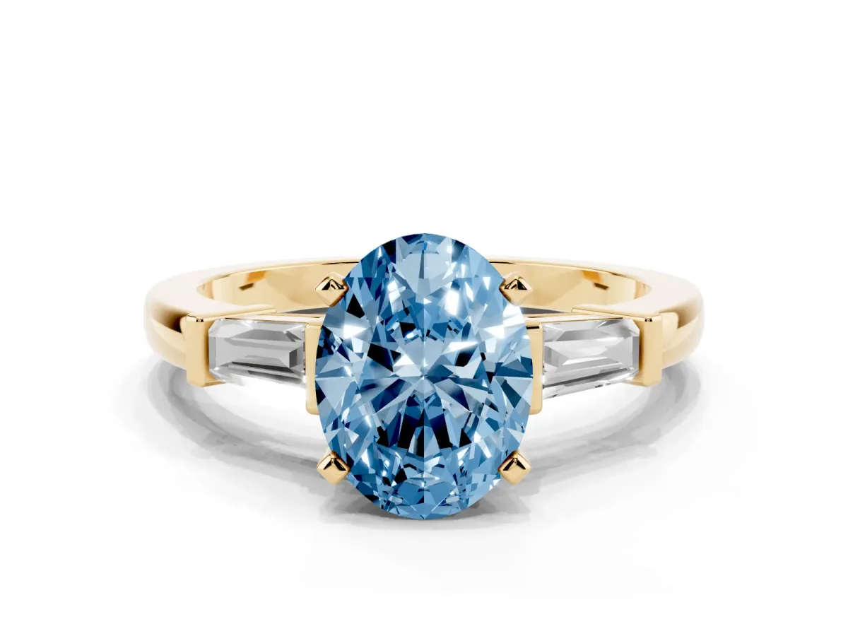Fancy Blue Oval Cut Cut Diamond Solitaire Ring with Tapered Baguette Accents and Four-Prong Setting Yellow gold