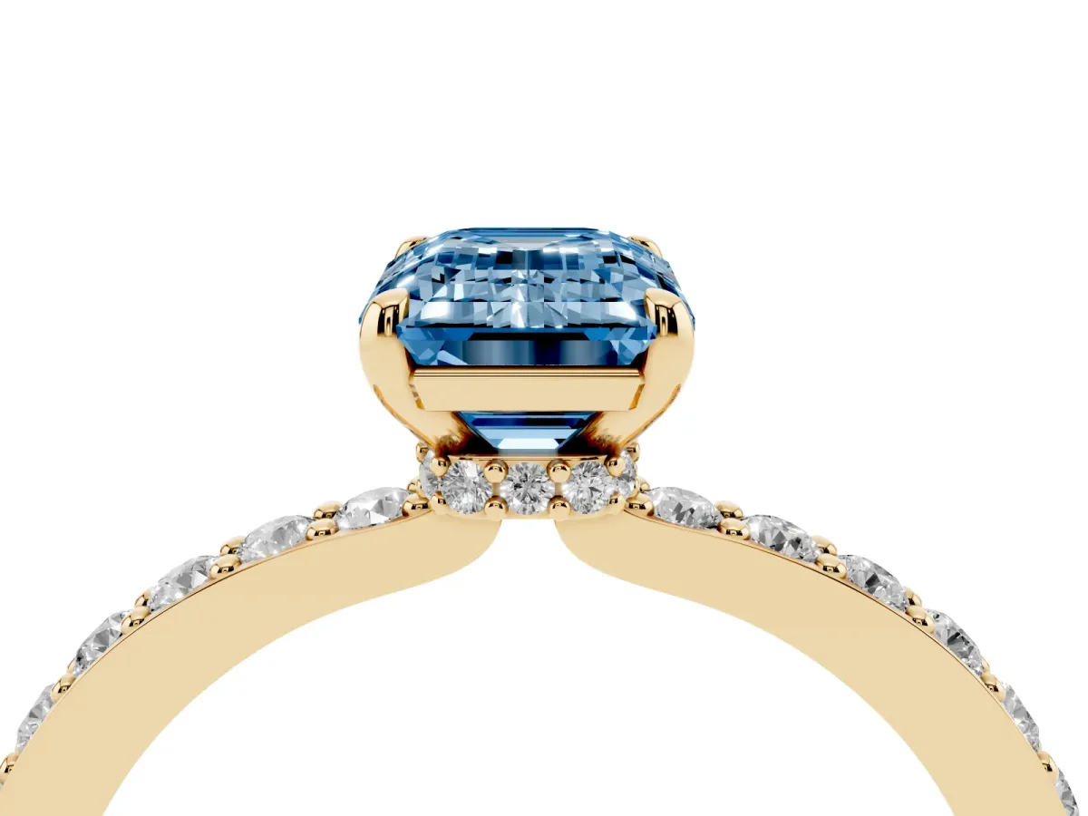 Fancy Blue Emerald Cut Diamond Solitaire Engagement Ring with Pavé Band and Four-Prong Setting Yellow gold