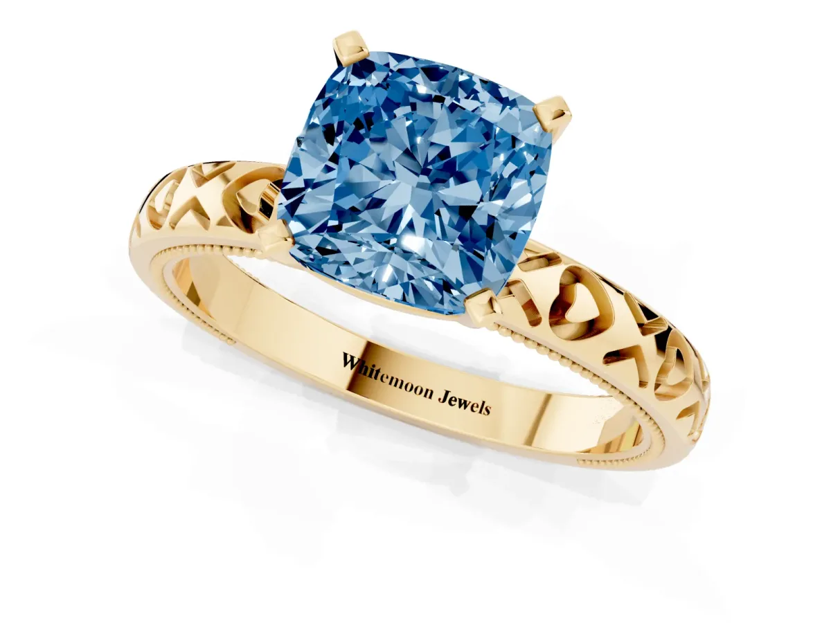 Fancy Blue Cushion Cut Solitaire Diamond Engagement Ring with XO Engraved Band and Four-Prong Setting Yellow gold