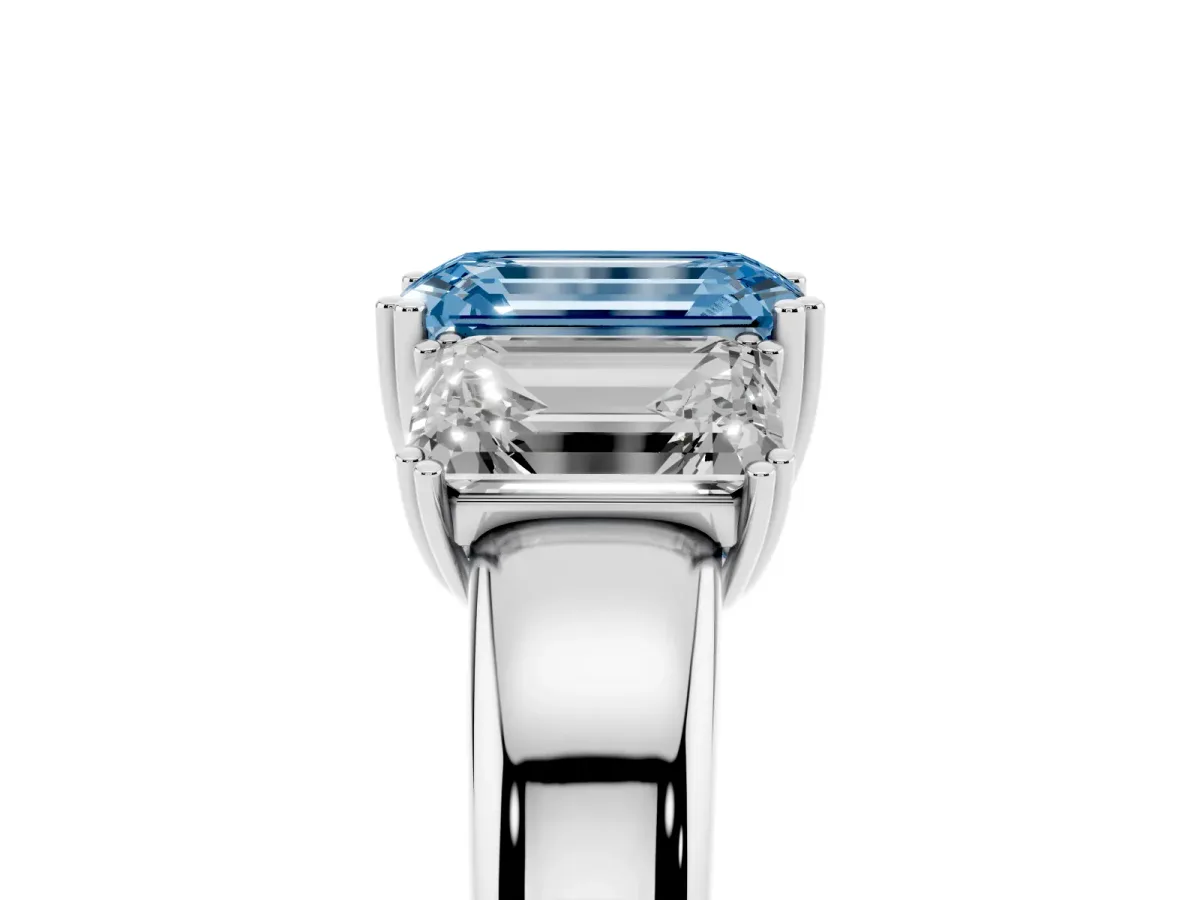 Fancy Blue Three-Stone Emerald Cut Cut Diamond Ring with Channel Set Band and Four-Prong Setting Silver