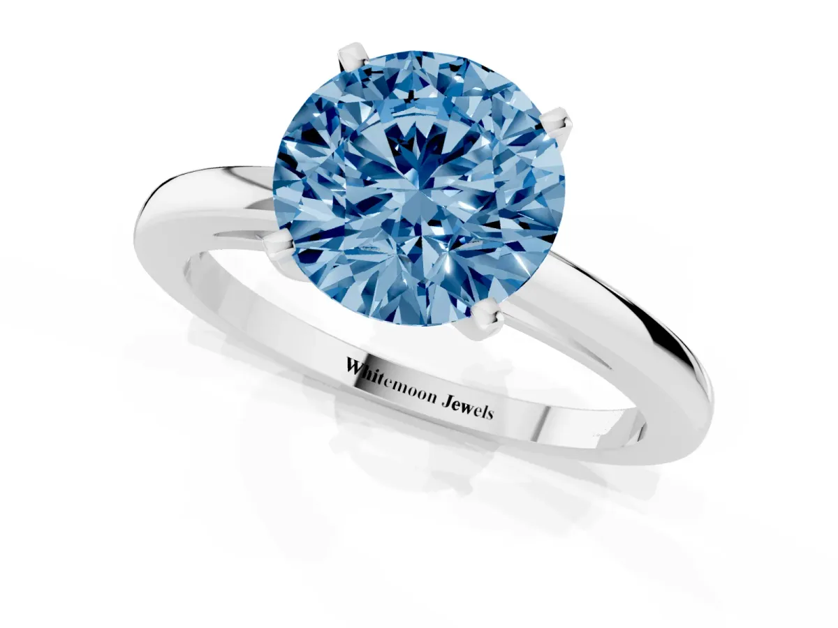 Fancy Blue Round Cut Solitaire Diamond Engagement Ring with Four-Prong Setting on a Classic Band Silver