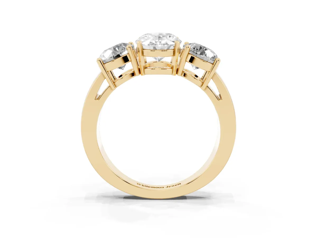Three-Stone Oval Cut Diamond Ring with Round Side Stones, Classic Band, and Four-Prong Setting Yellow gold
