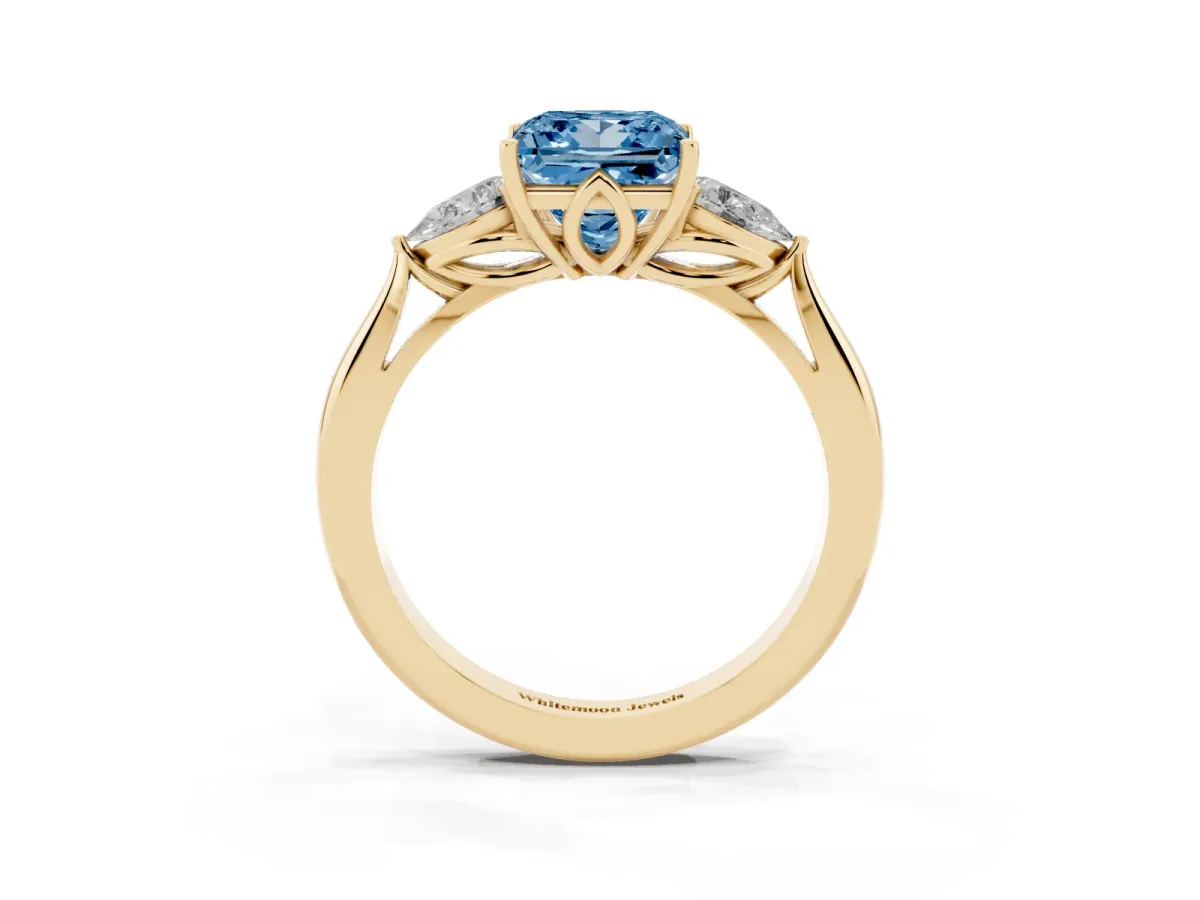 Fancy Blue Three-Stone Princess Cut Diamond Ring with Pear Side Stones in Four-Prong Setting Yellow gold