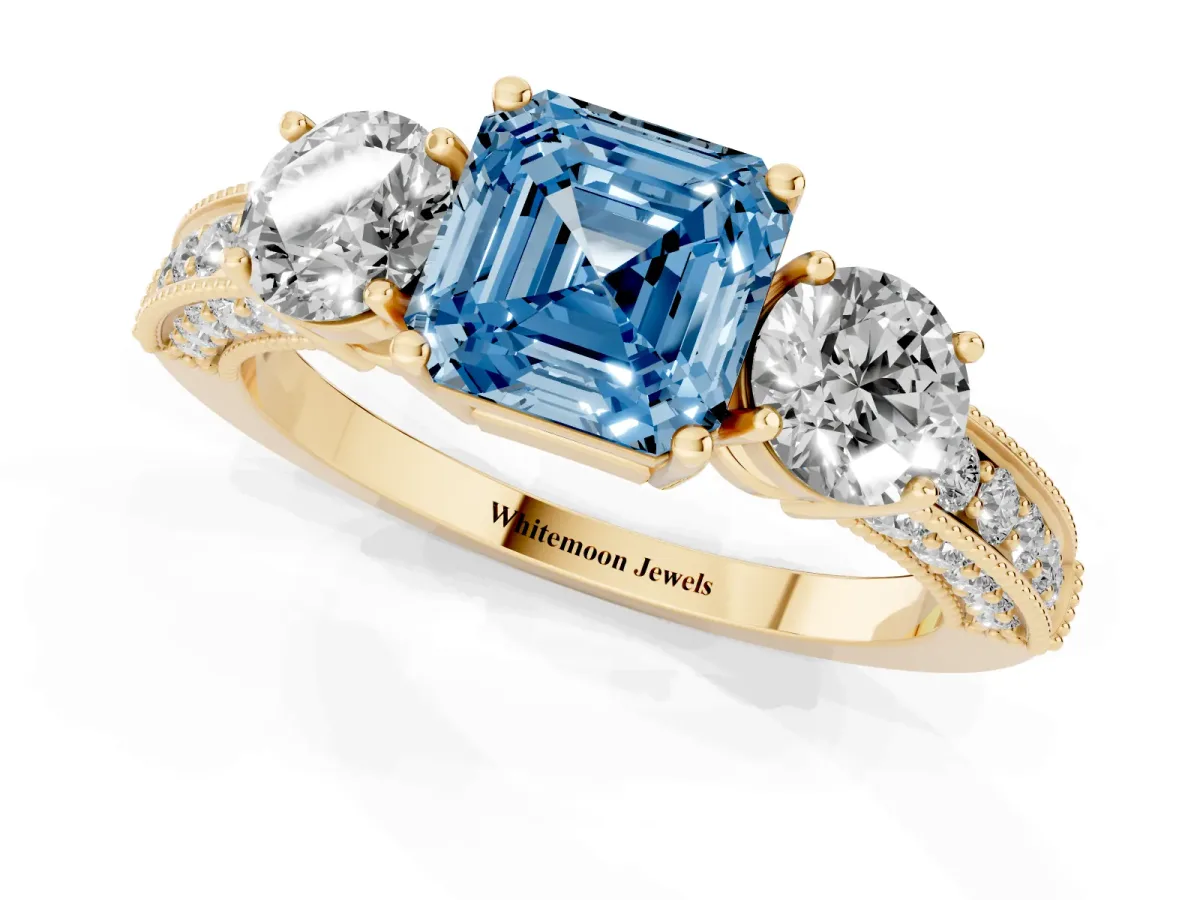 Fancy Blue Asscher Cut Three-Stone Diamond Ring with Pavé Band and Four-Prong Setting Yellow gold