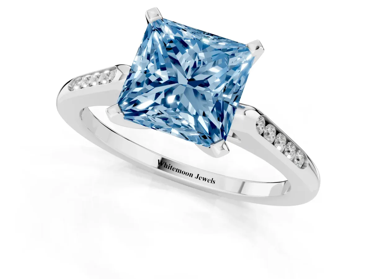 Fancy Blue Princess Cut Diamond Solitaire Ring with Channel Set Round Band and Prong Setting Silver