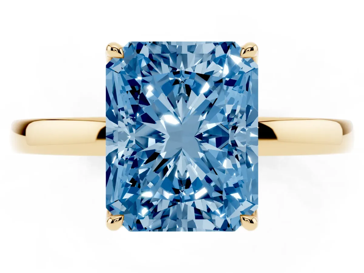 Fancy Blue Radiant Cut Diamond Solitaire Ring with Thin Band and Prong Setting Yellow gold