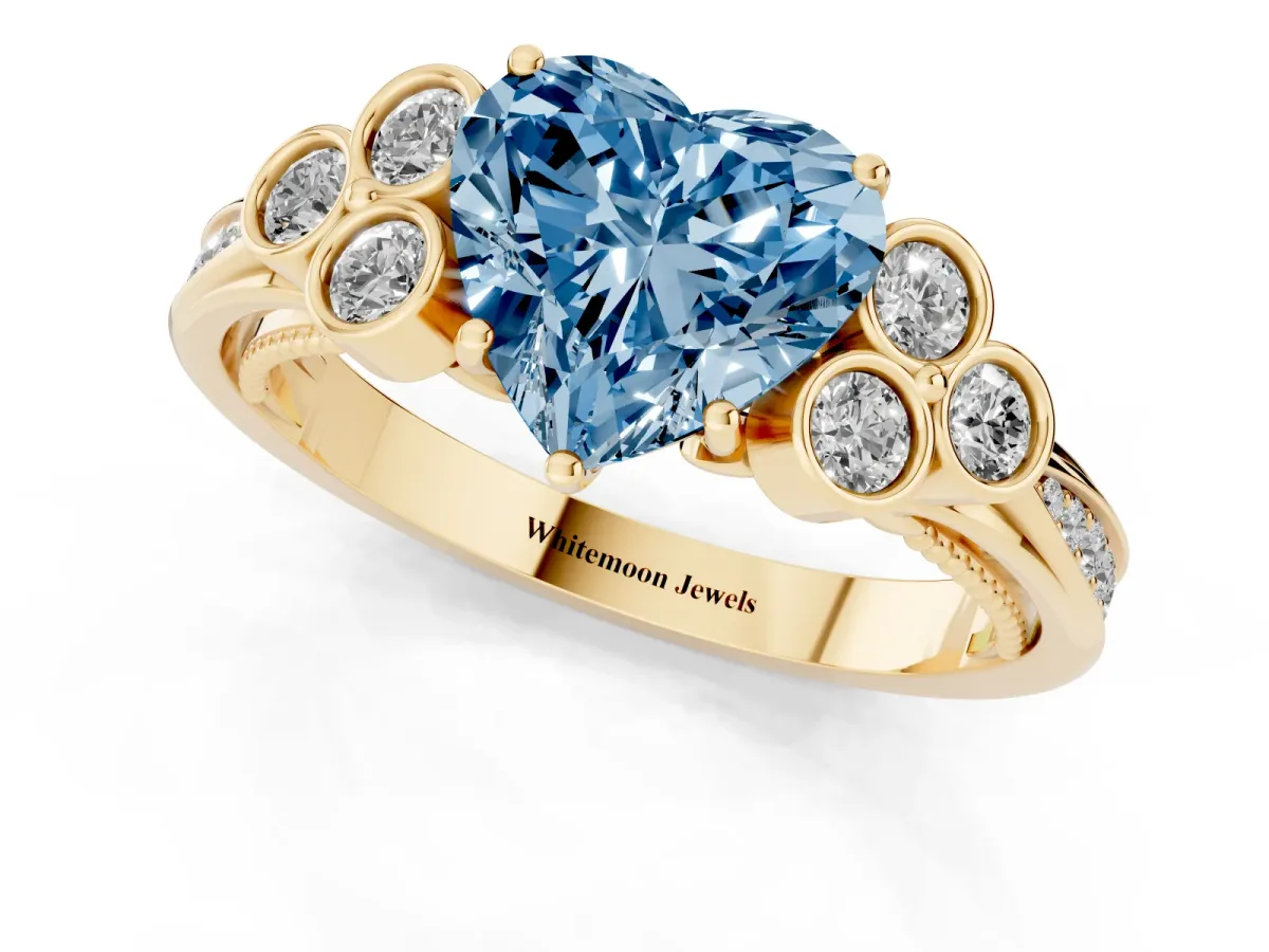 Fancy Blue Heart Cut Cut Diamond Engagement Ring with Bezel Set Round Side Stones and Prong Setting Yellow gold