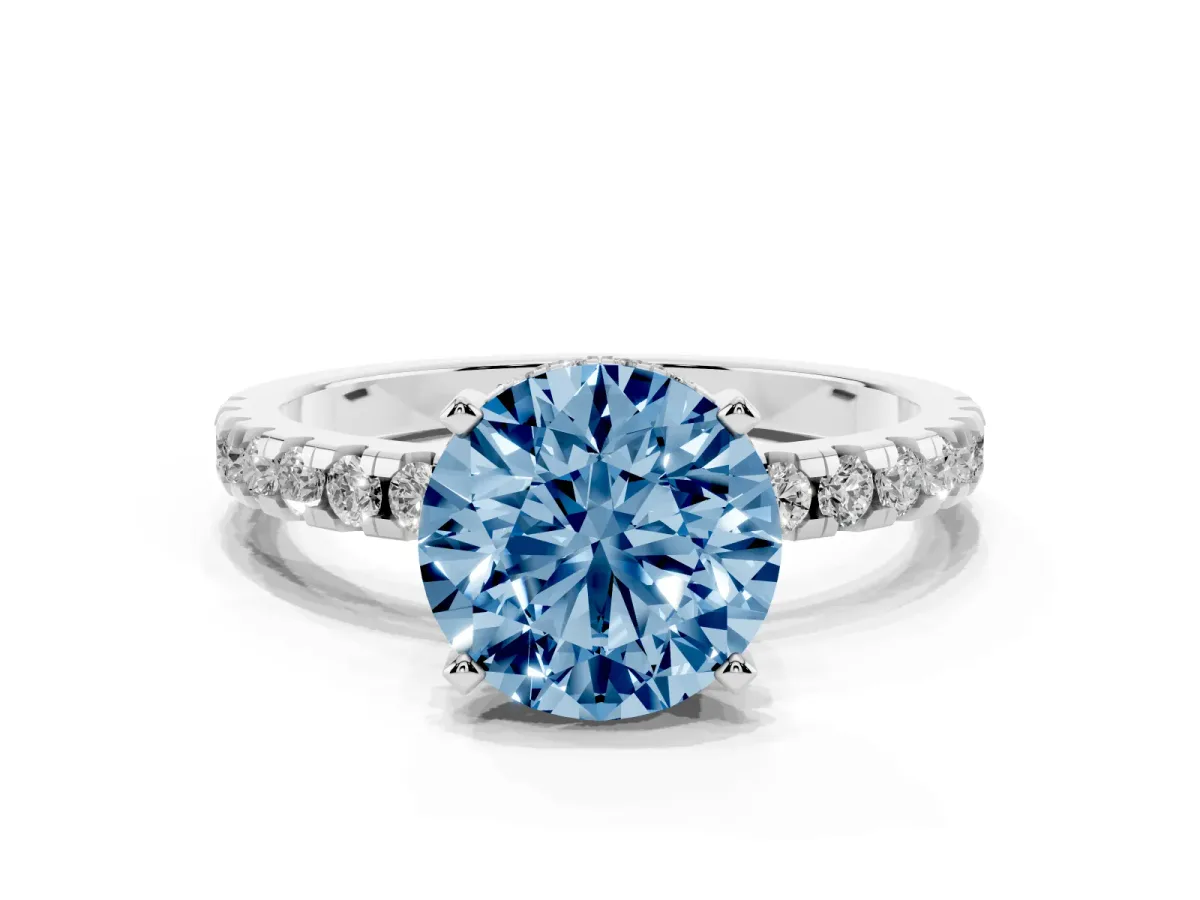 Fancy Blue Round Cut Diamond Solitaire Ring with Round Pavé Band and Four-Prong Setting Silver