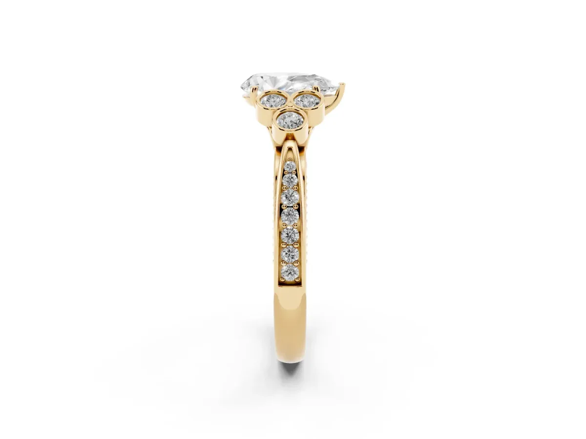 Pear Cut Cut Diamond Engagement Ring with Bezel Set Round Side Stones and Prong Setting Yellow gold
