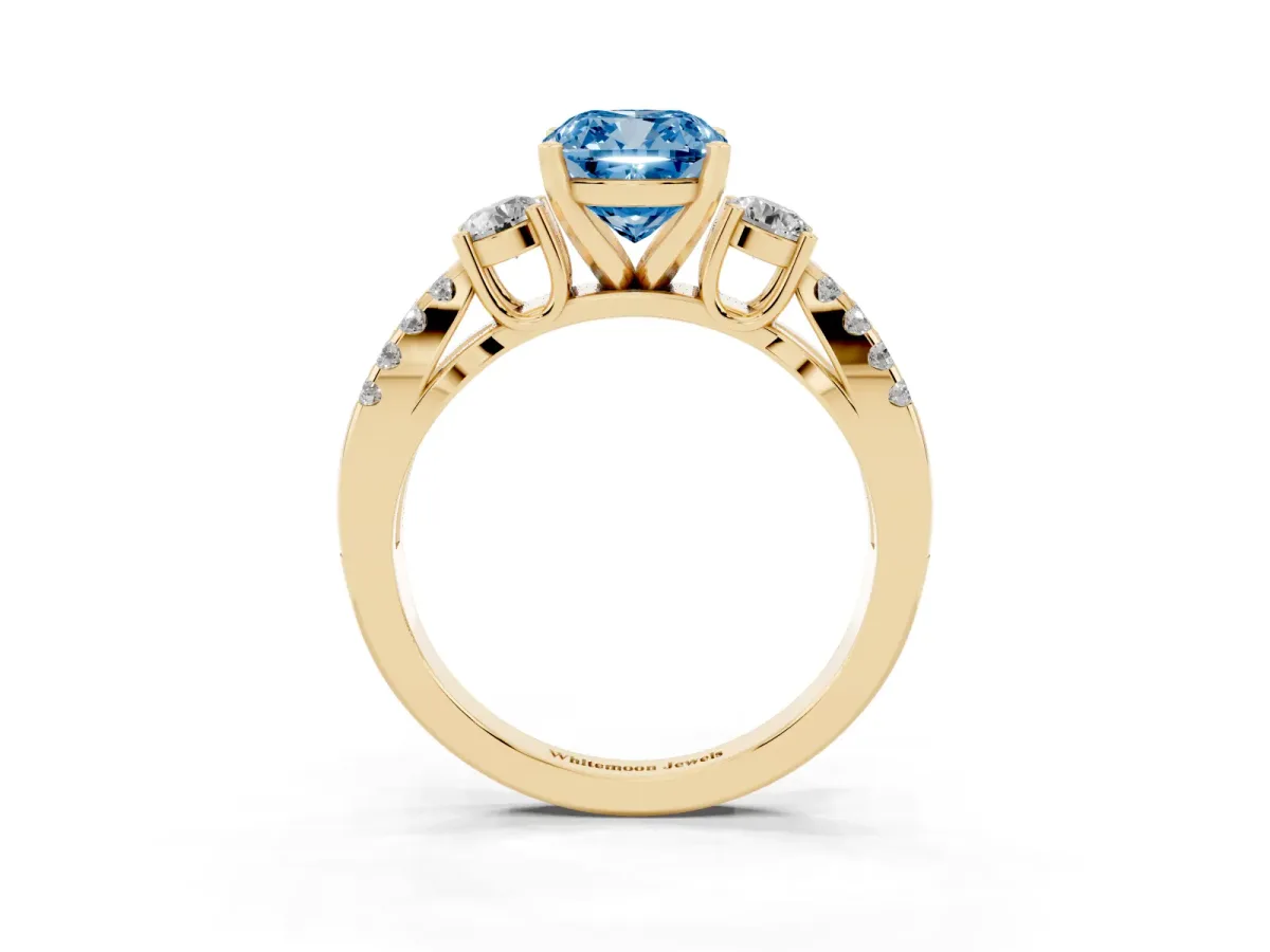 Fancy Blue Cushion Cut Diamond Three-Stone Ring with Pavé Split Shank and Four-Prong Setting Yellow gold