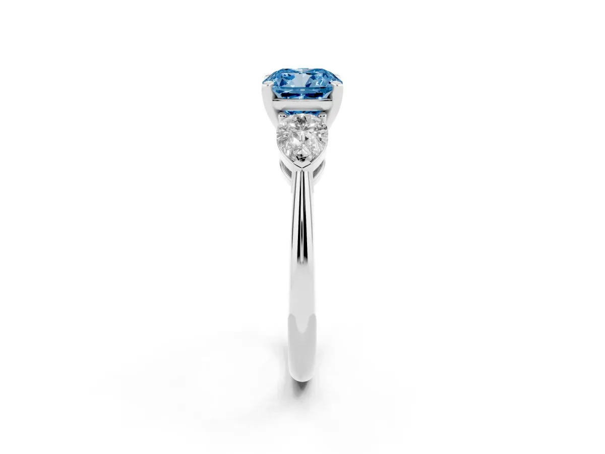 Fancy Blue Three-Stone Cushion Cut Diamond Ring with Pear Side Stones and Four-Prong Setting Platinum