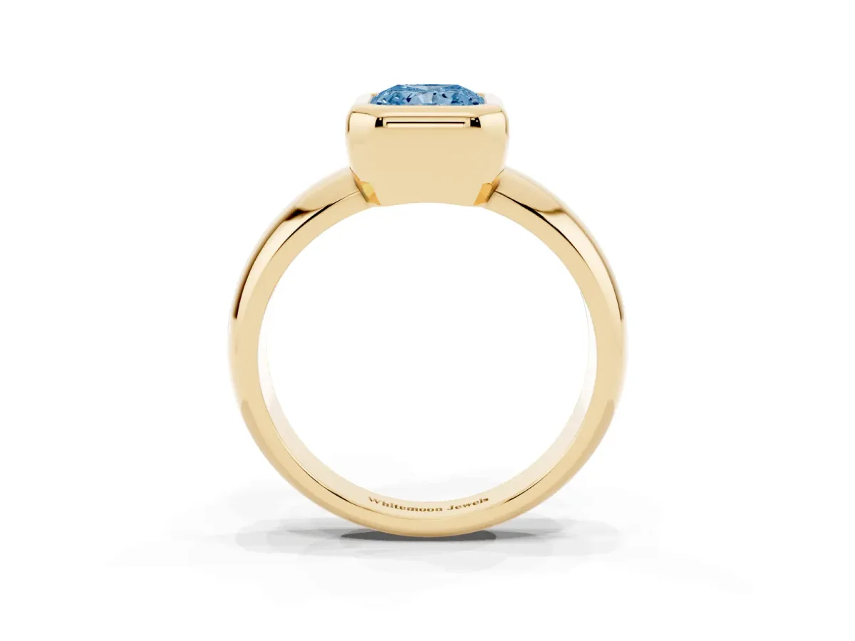 Fancy Blue Bezel Set Radiant Cut Solitaire Ring with Wide Band Yellow gold