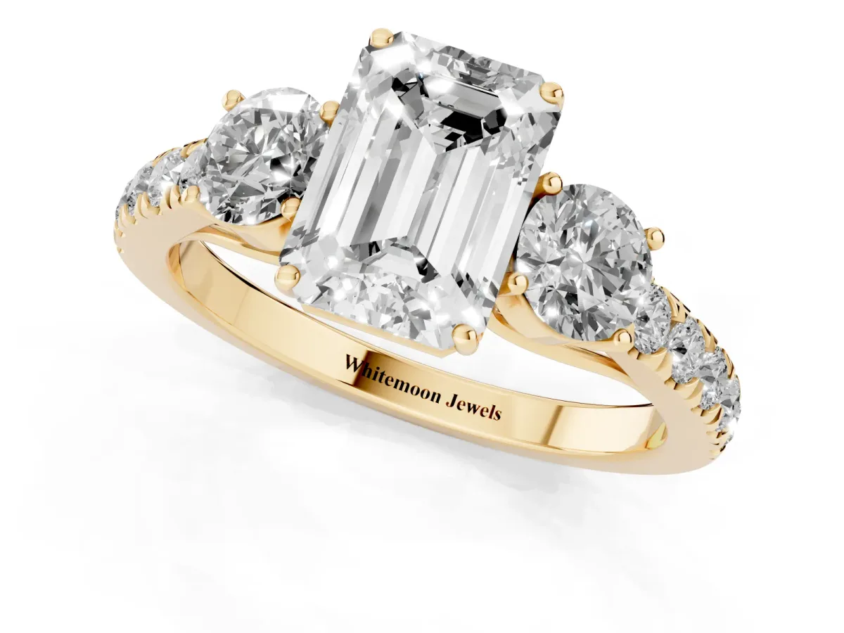 Emerald Cut Cut Diamond Three-Stone Ring with Round Side Stones and Pavé Band Yellow gold