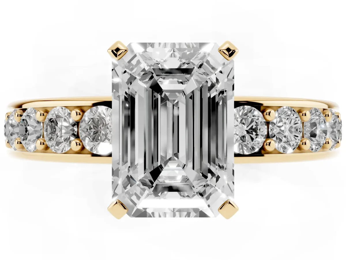 Emerald Cut Diamond Engagement Ring with Channel Set Round Band and Prong Setting Yellow gold