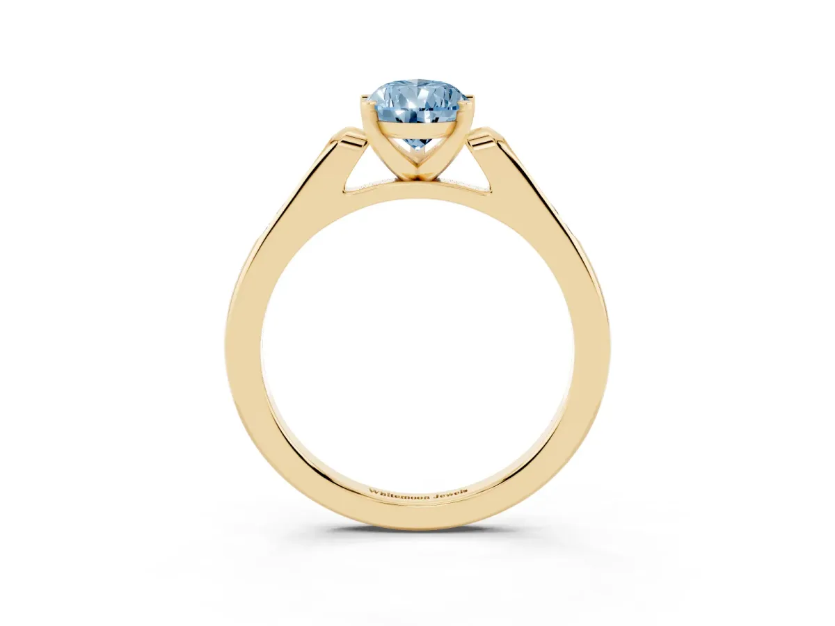 Fancy Blue Pear Cut Diamond Solitaire Ring with Channel Set Round Band and Prong Setting Yellow gold